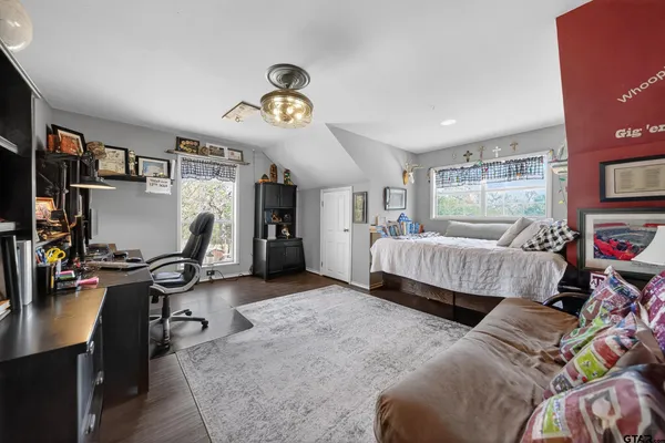a bedroom with furniture and a flat screen tv
