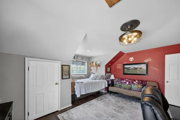 a bedroom with bed and a chandelier