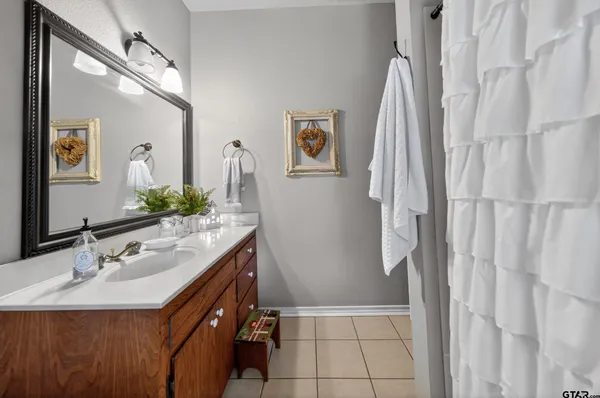 a bathroom with a sink vanity and a mirror