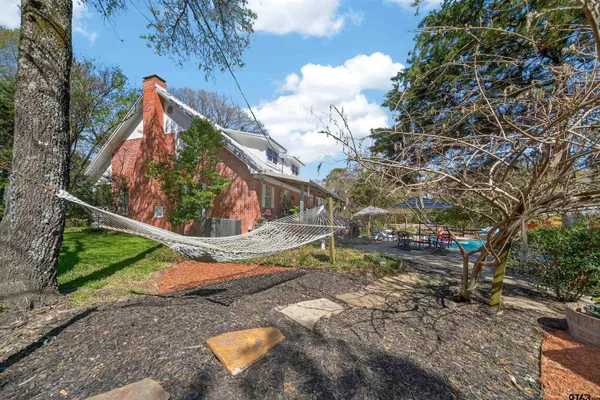 a view of a backyard with wooden fence