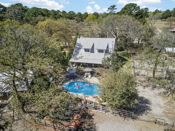 an aerial view of a house with a yard