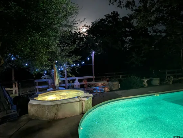 a view of a swimming pool with a patio