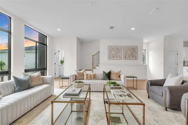 a living room with furniture and a large window