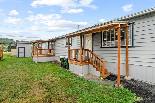 a view of a house with a backyard and a patio