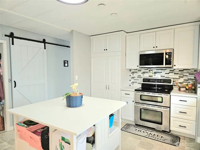 a kitchen with a appliances and a stove top oven