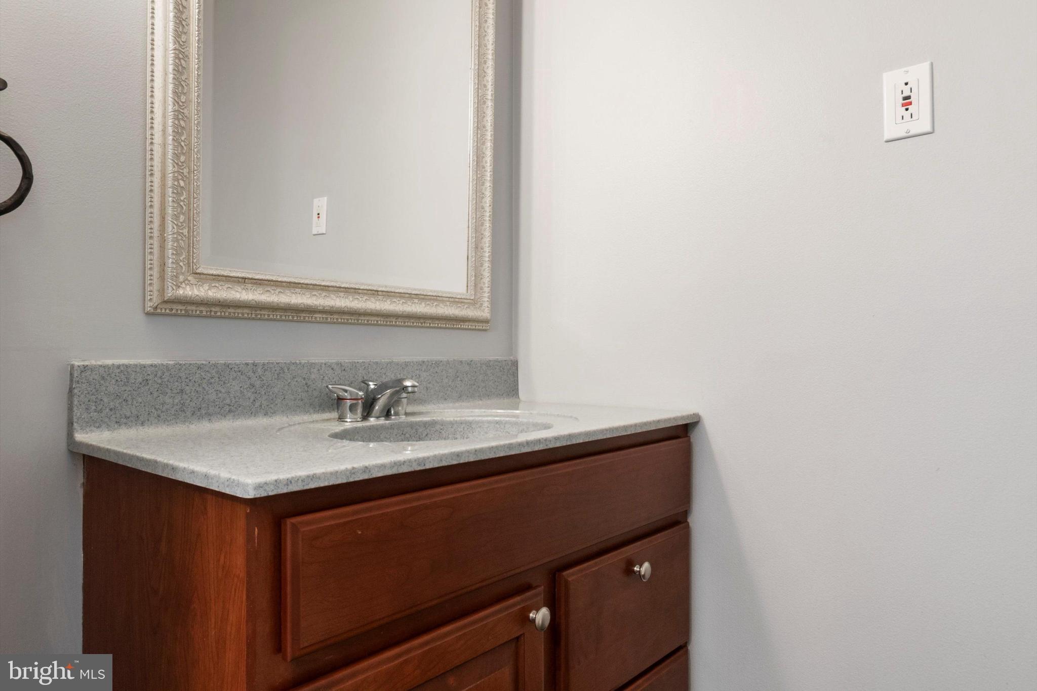 273 Delmar Street Philadelphia, PA 19128 - Photo 14 of 34 a bathroom with a granite countertop sink and a mirror