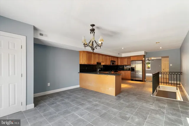 a view of kitchen with a refrigerator and a sink