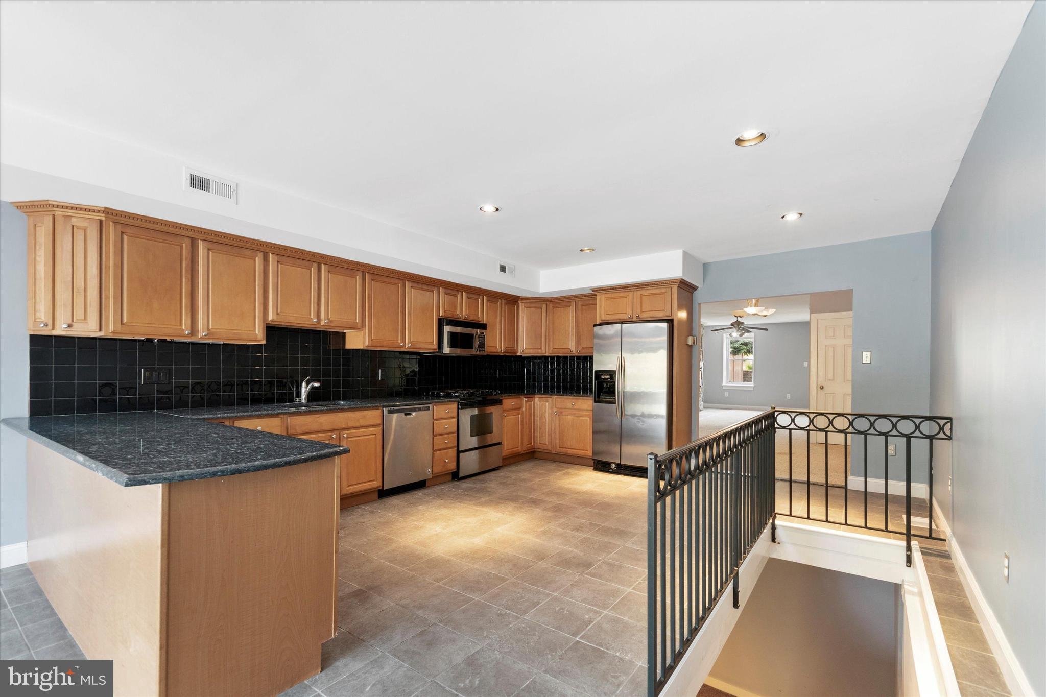 273 Delmar Street Philadelphia, PA 19128 - Photo 17 of 34 a kitchen with stainless steel appliances granite countertop a sink counter space and cabinets