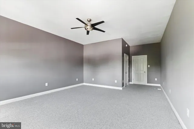 a view of a livingroom with a ceiling fan and window