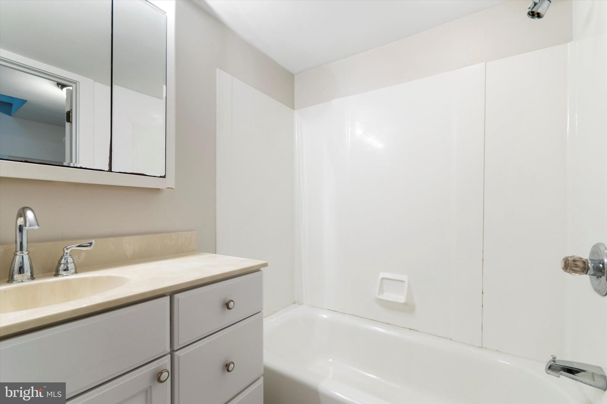 273 Delmar Street Philadelphia, PA 19128 - Photo 28 of 34 a bathroom with a sink a vanity and mirror