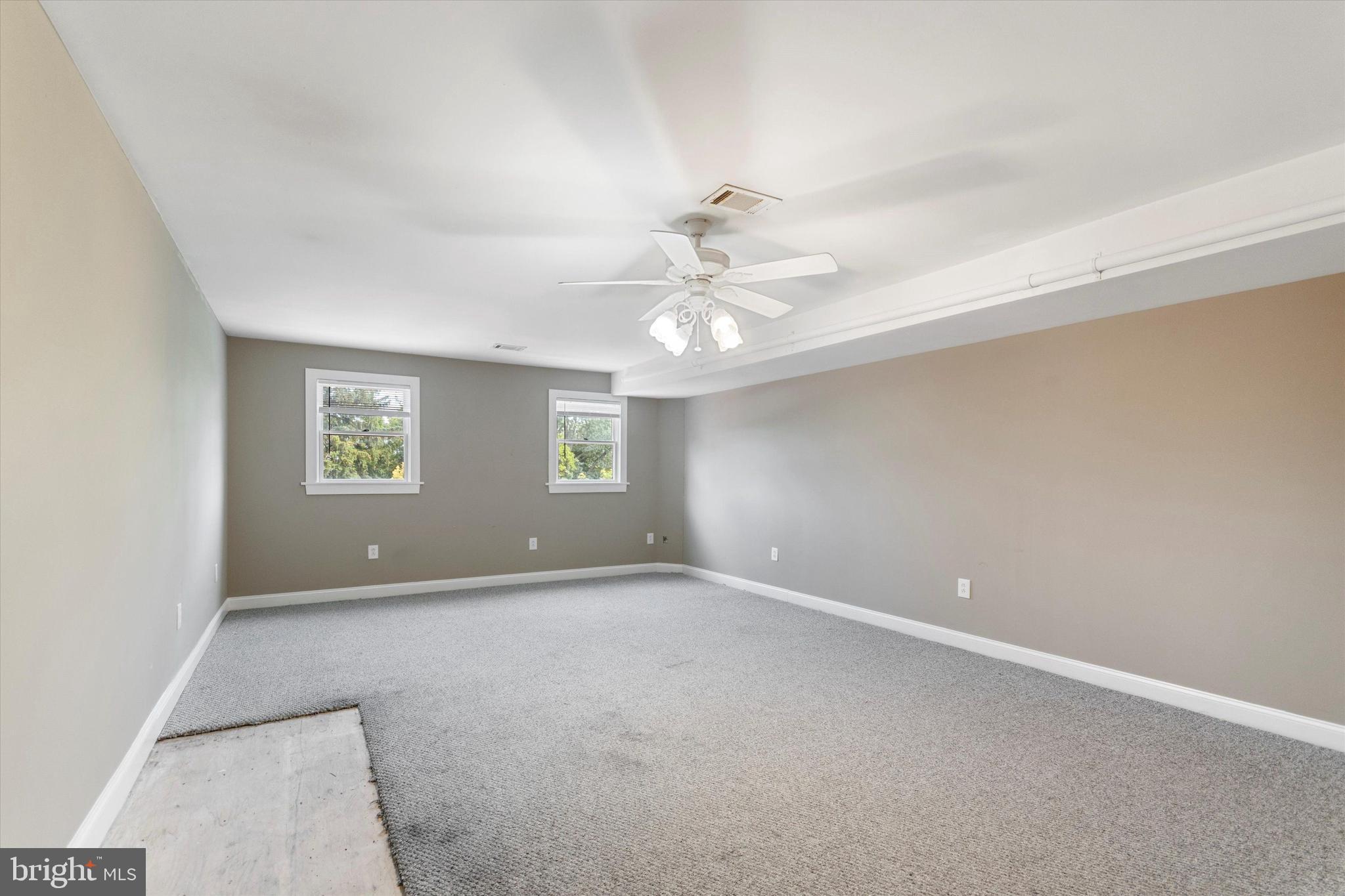 273 Delmar Street Philadelphia, PA 19128 - Photo 31 of 34 an empty room with windows and chandelier fan