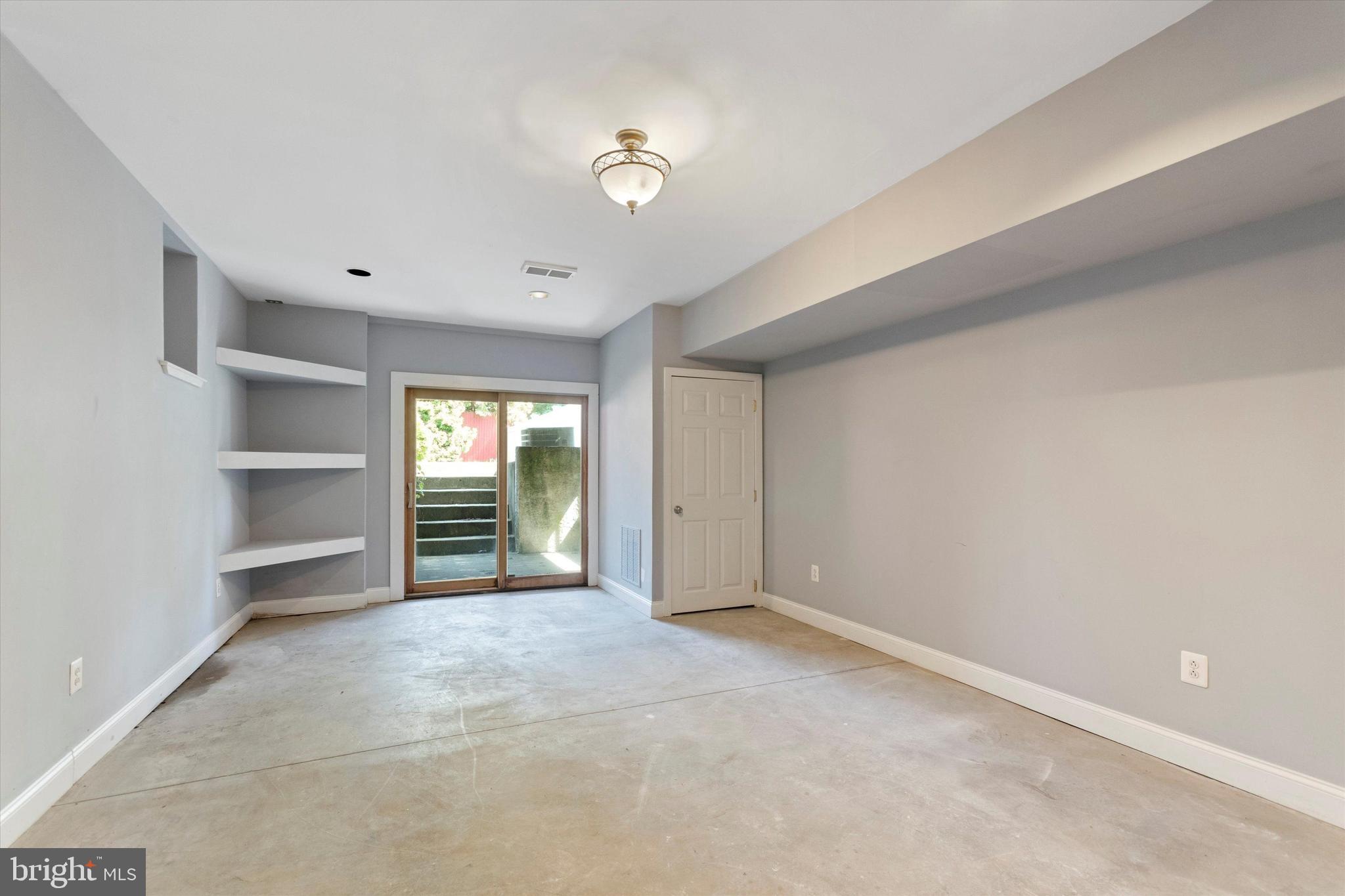273 Delmar Street Philadelphia, PA 19128 - Photo 33 of 34 a view of an empty room with a window and cabinet