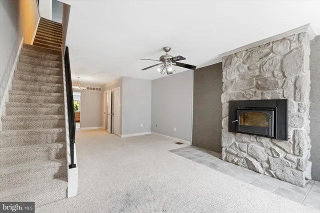 a view of an empty room and fire place
