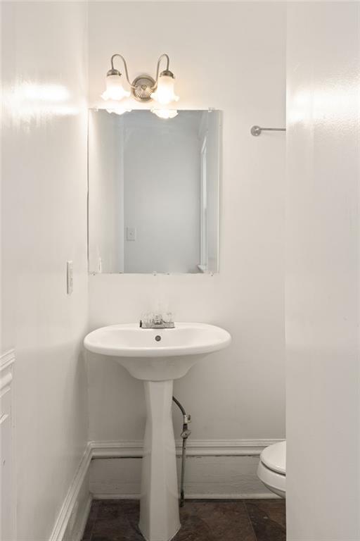 120 South Candler Street Decatur, GA 30030 - Photo 38 of 40 a bathroom with a sink a toilet and mirror