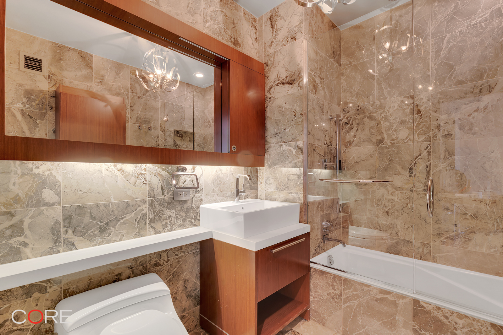 Undisclosed Address Manhattan, NY 10011 - Photo 6 of 14 a bathroom with a tub sink and mirror