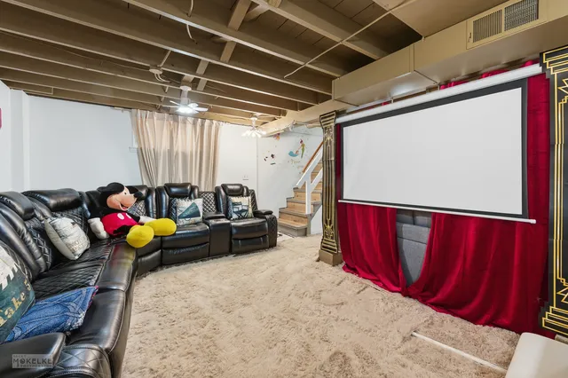 a view of a hallway with couch and chairs