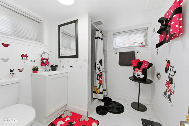 a bathroom with a bathtub sink mirror and vanity