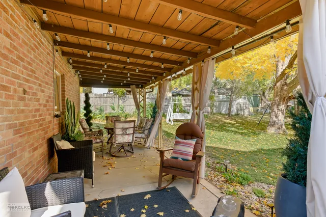 a view of balcony with couch and chairs
