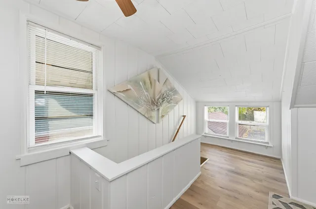 a living room with a window and a wooden floor
