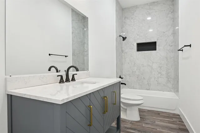 a bathroom with a sink toilet and shower