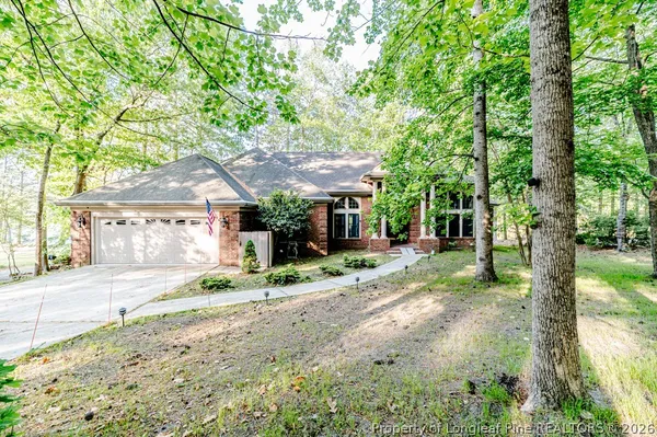a view of a house with a tree in the yard