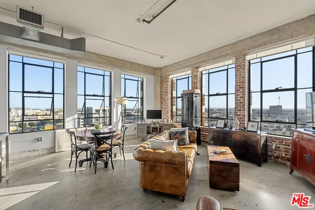 a living room with furniture and floor to ceiling windows
