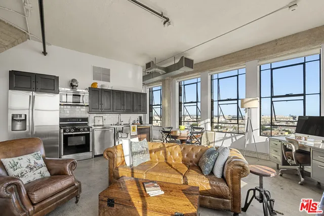 a kitchen with stainless steel appliances a refrigerator a stove a sink and dishwasher