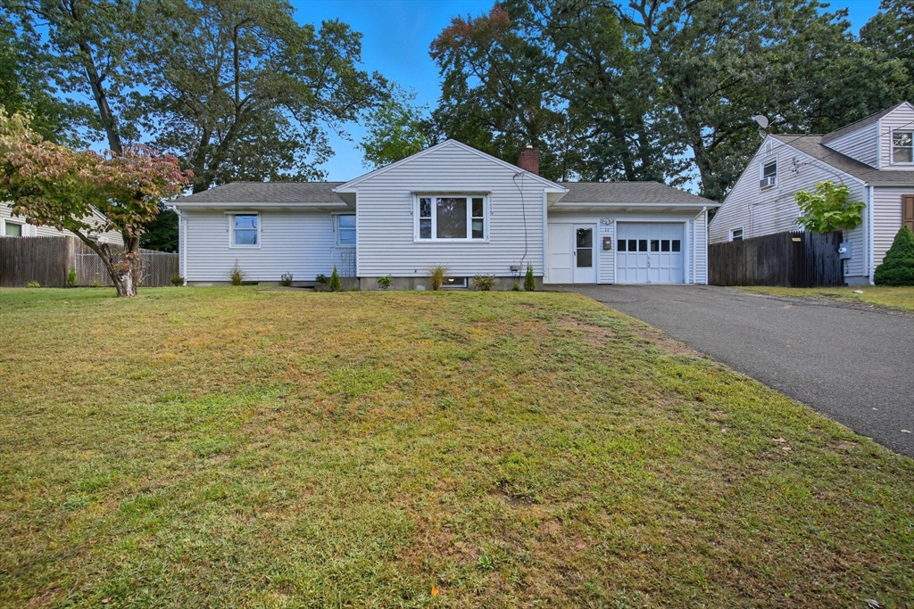 a large house with a big yard and large trees