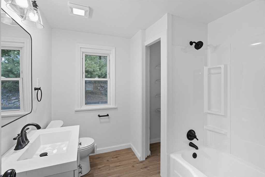 11 Copeland Street Springfield, MA 01108 - Photo 11 of 27 a bathroom with a tub sink and mirror