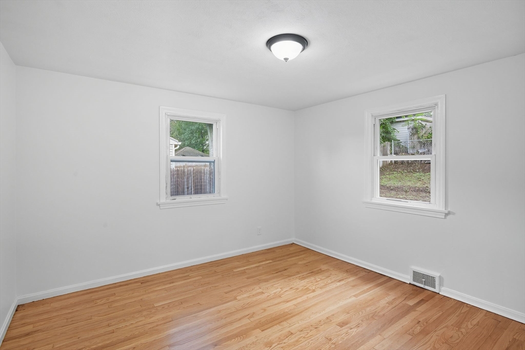 11 Copeland Street Springfield, MA 01108 - Photo 15 of 27 a view of empty room with wooden floor and fan