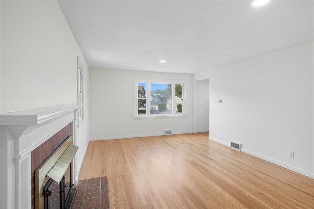 11 Copeland Street Springfield, MA 01108 - Photo 7 of 27 an empty room with wooden floor and windows