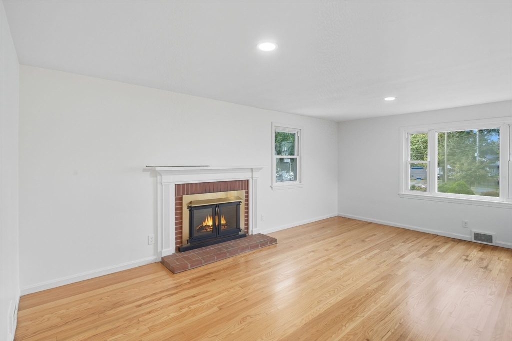 11 Copeland Street Springfield, MA 01108 - Photo 8 of 27 wooden floor fireplace and windows in an empty room