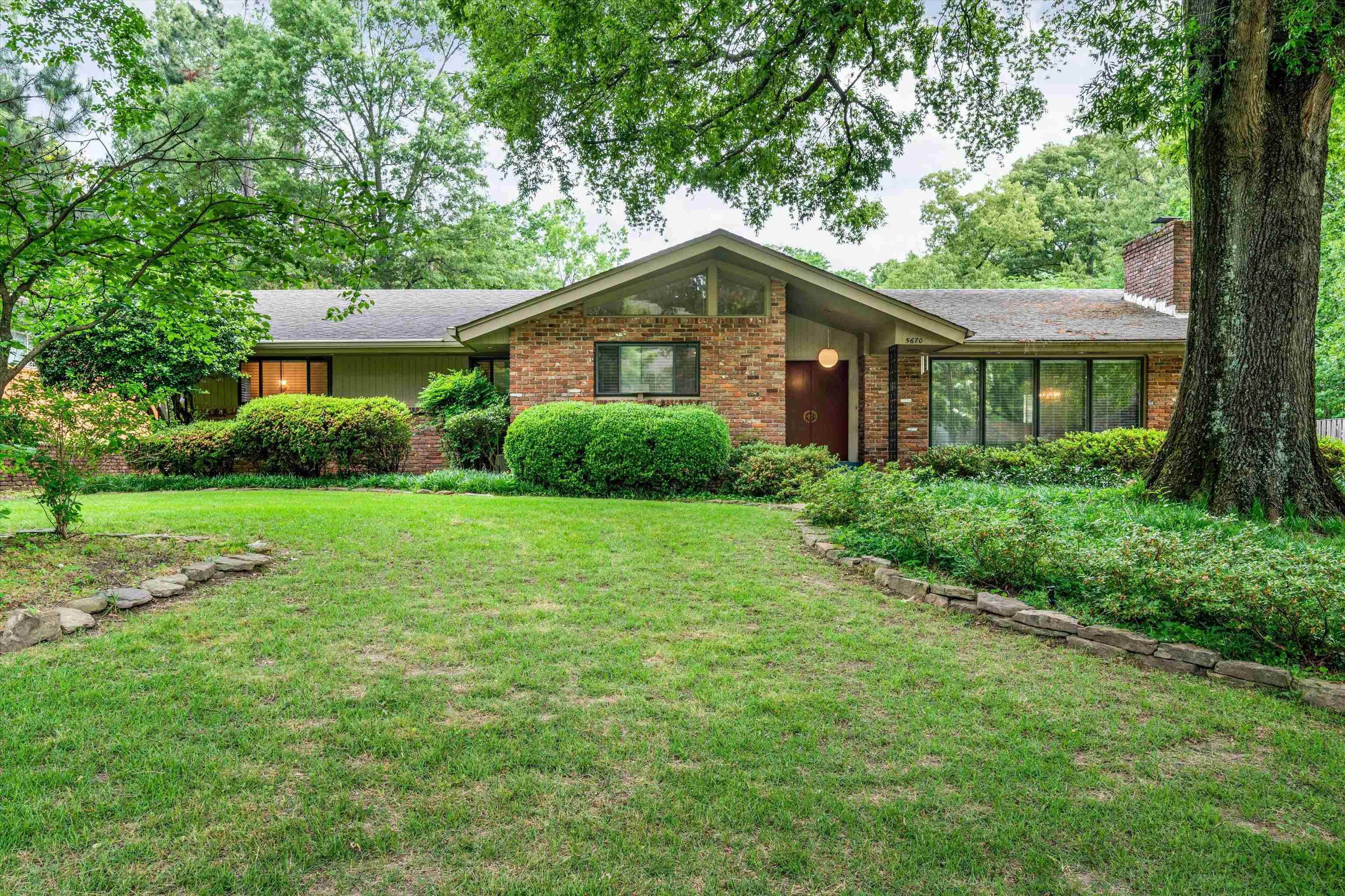5670 North Angela Road Memphis, TN 38120 - Photo 1 of 22 a front view of a house with yard and green space