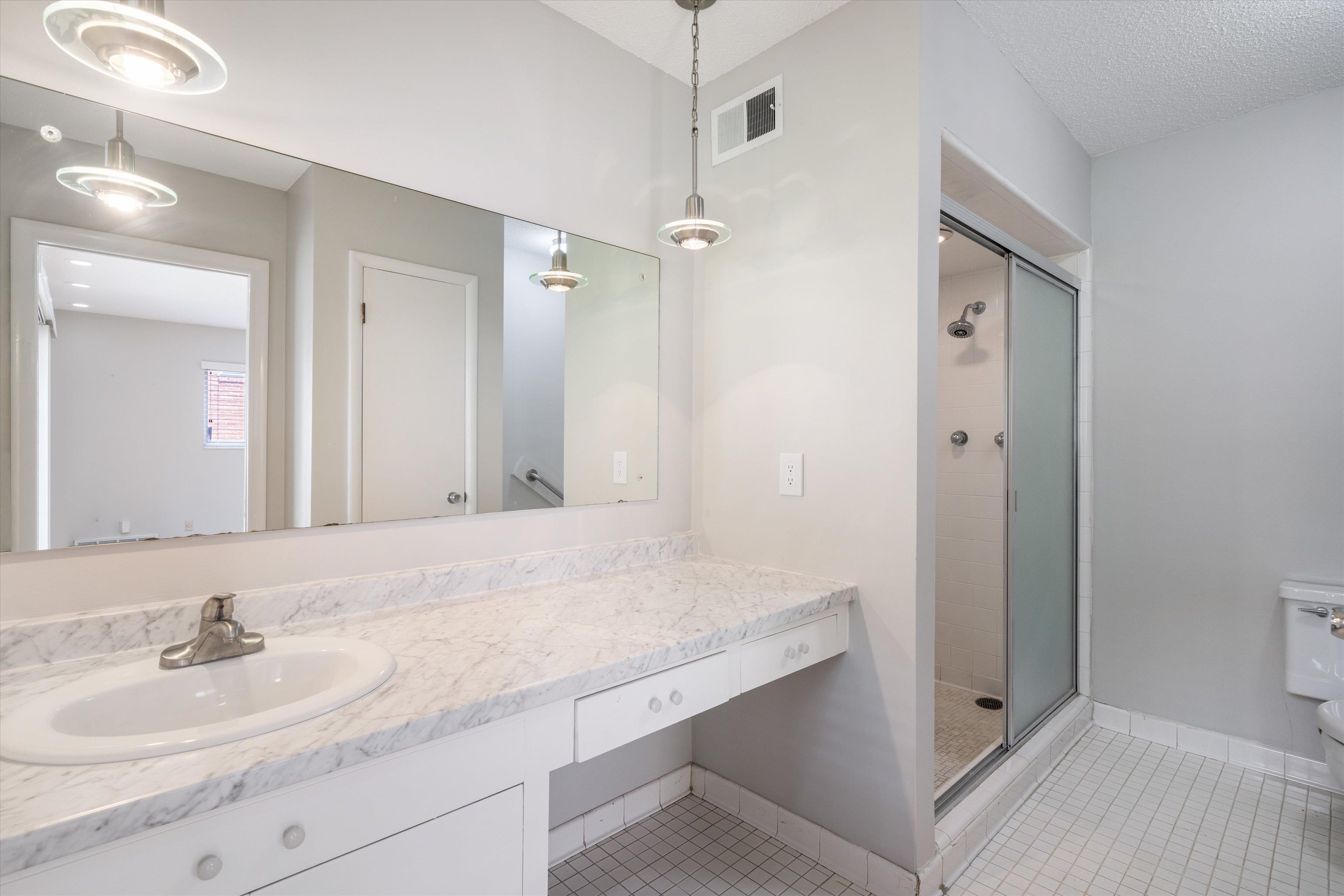 5670 North Angela Road Memphis, TN 38120 - Photo 14 of 22 a bathroom with a granite countertop sink mirror and double