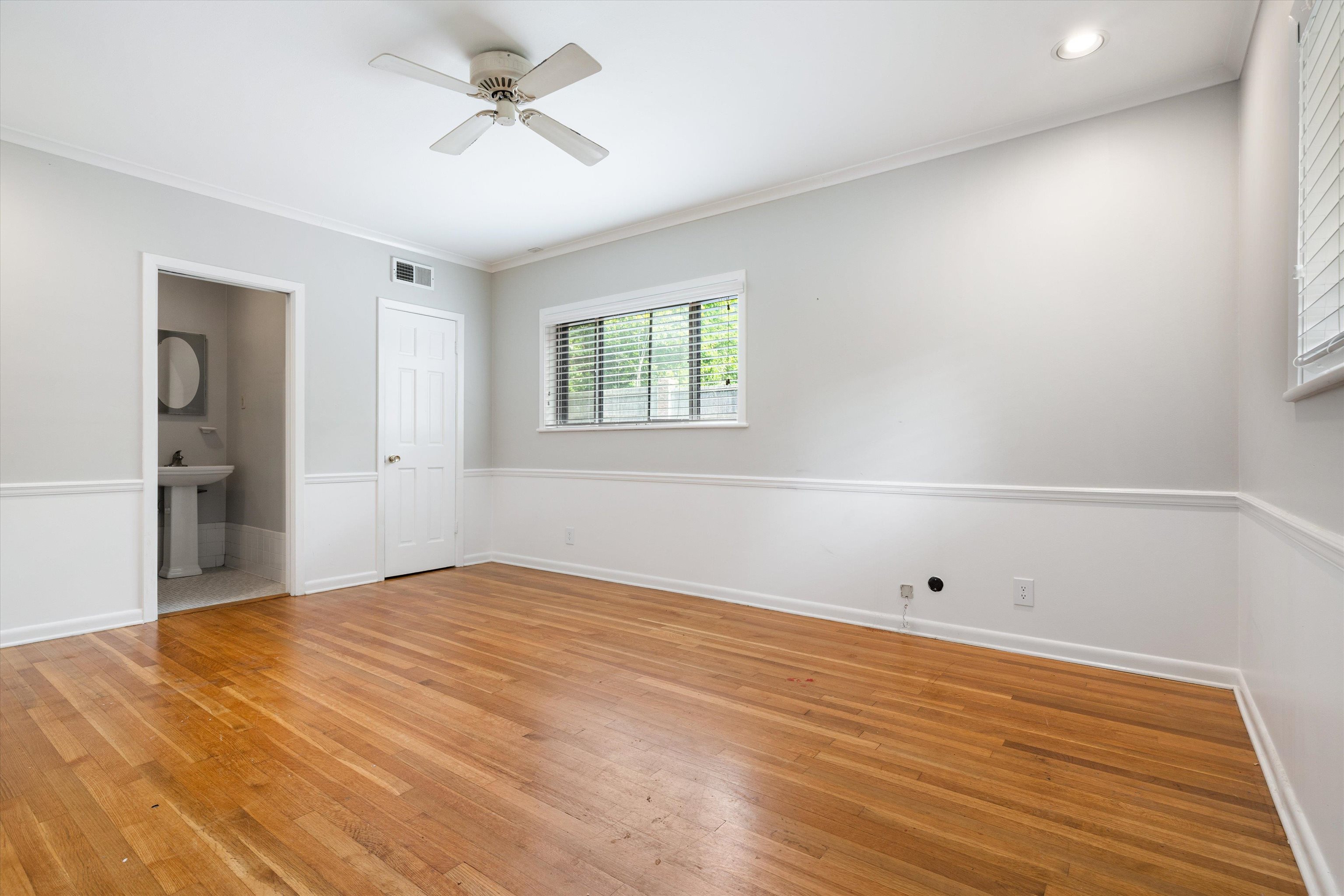 5670 North Angela Road Memphis, TN 38120 - Photo 18 of 22 wooden floor in an empty room with a window