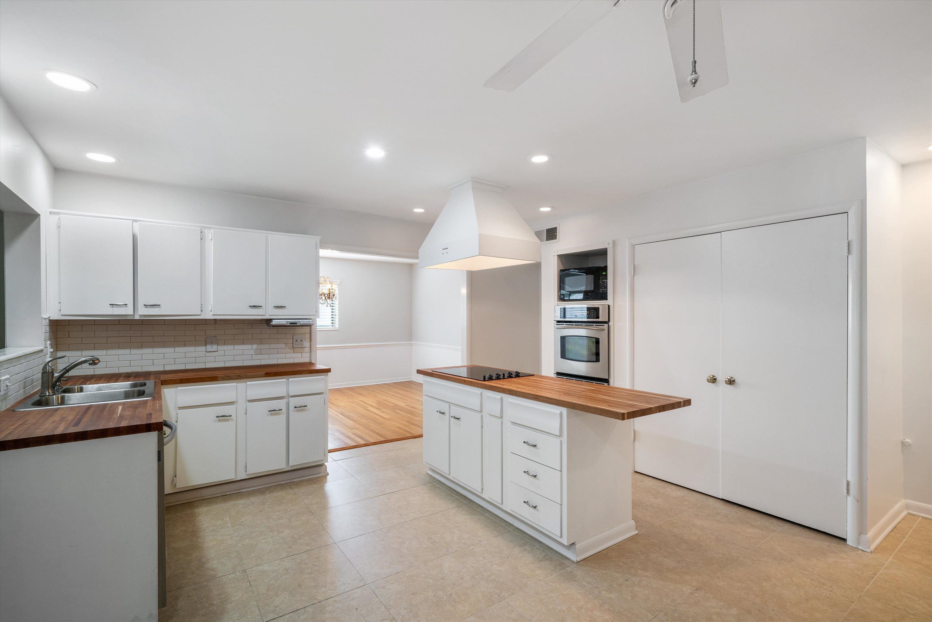 5670 North Angela Road Memphis, TN 38120 - Photo 7 of 22 a kitchen with stainless steel appliances granite countertop a sink and cabinets