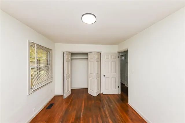a view of a room with wooden floor and window