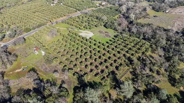 an aerial view of house with yard and mountain view in back