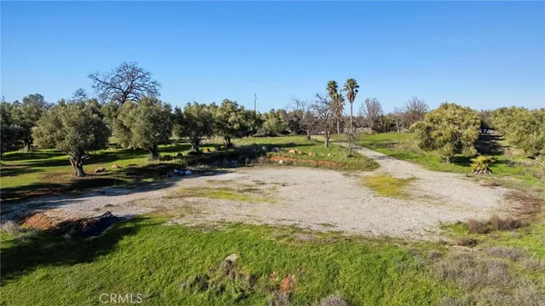 a view of a yard with wooden fence
