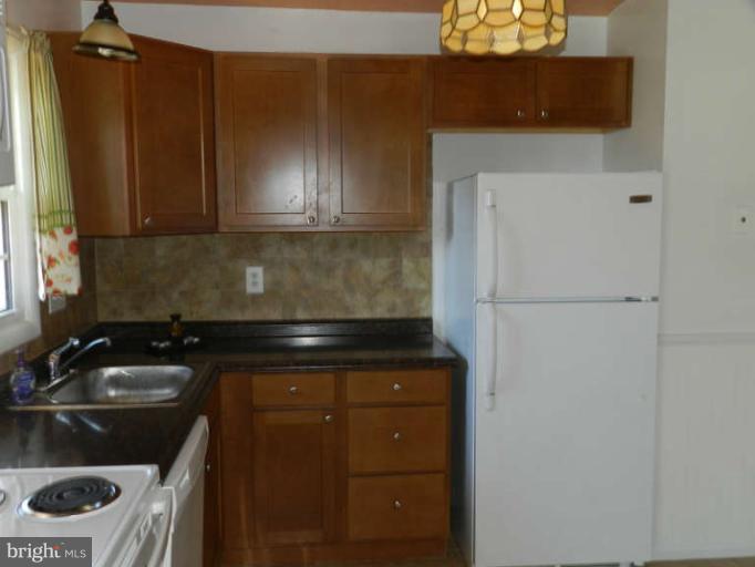 1849 Montreal Road Severn, MD 21144 - Photo 5 of 23 a kitchen with a sink and a refrigerator