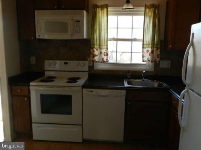 1849 Montreal Road Severn, MD 21144 - Photo 8 of 23 a kitchen with a stove and a microwave