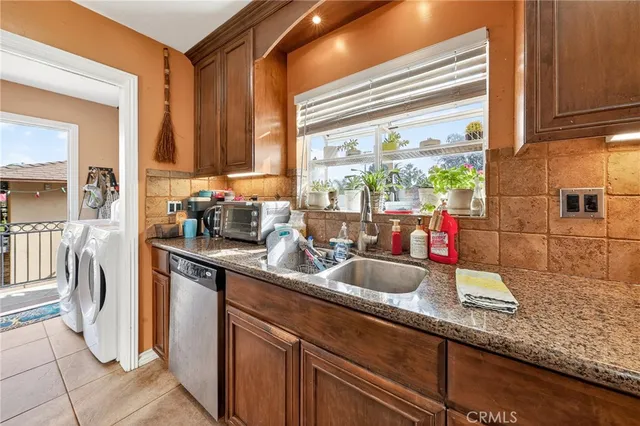 a kitchen with sink a window and stainless steel appliances