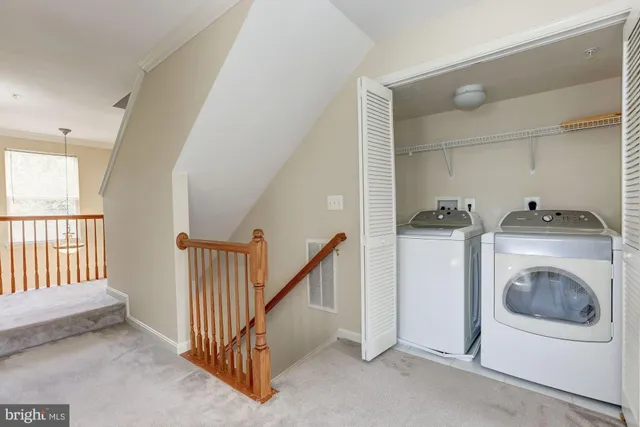 a view of a hallway with washer and dryer