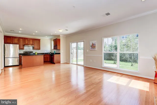 a view of kitchen with wooden floor and electronic appliances