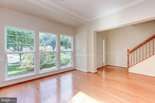 a view of an empty room with glass door and balcony