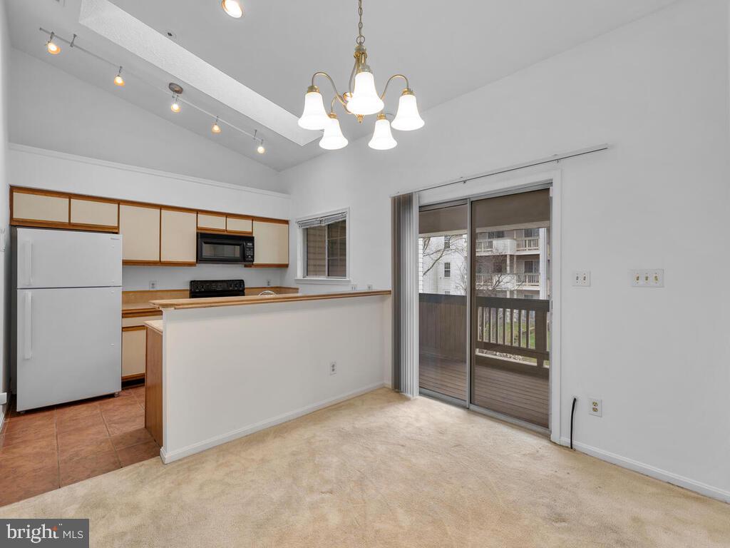 7806 Spinnaker Road, Unit 523 Laurel, MD 20707 - Photo 11 of 33 Kitchen w/ eat in bar area opens to deck