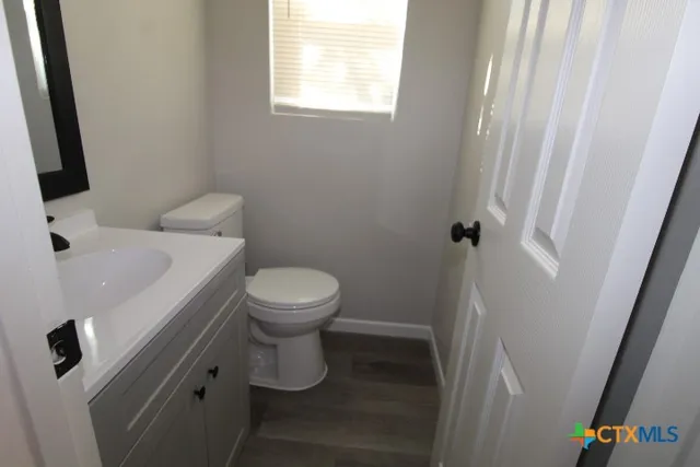 a white toilet sitting next to a sink