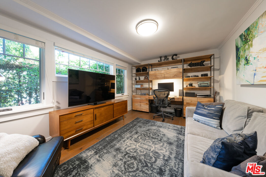 385 North Wilton Place Los Angeles, CA 90004 - Photo 20 of 53 a living room with furniture and a flat screen tv