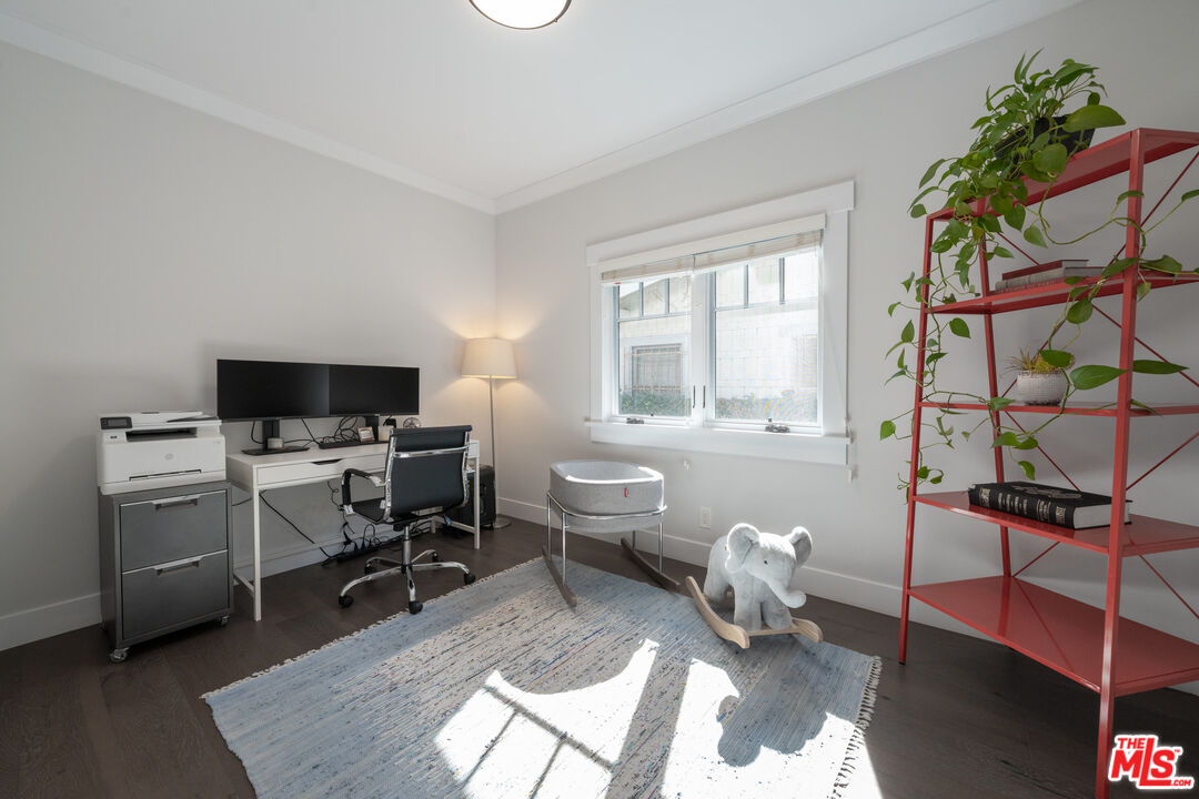 385 North Wilton Place Los Angeles, CA 90004 - Photo 24 of 53 a living room with furniture a flat screen tv and a window