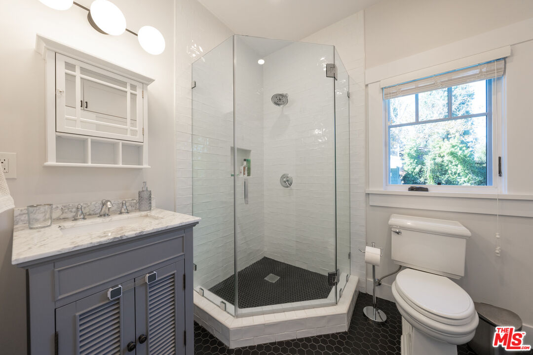 385 North Wilton Place Los Angeles, CA 90004 - Photo 29 of 53 a bathroom with a sink toilet and shower